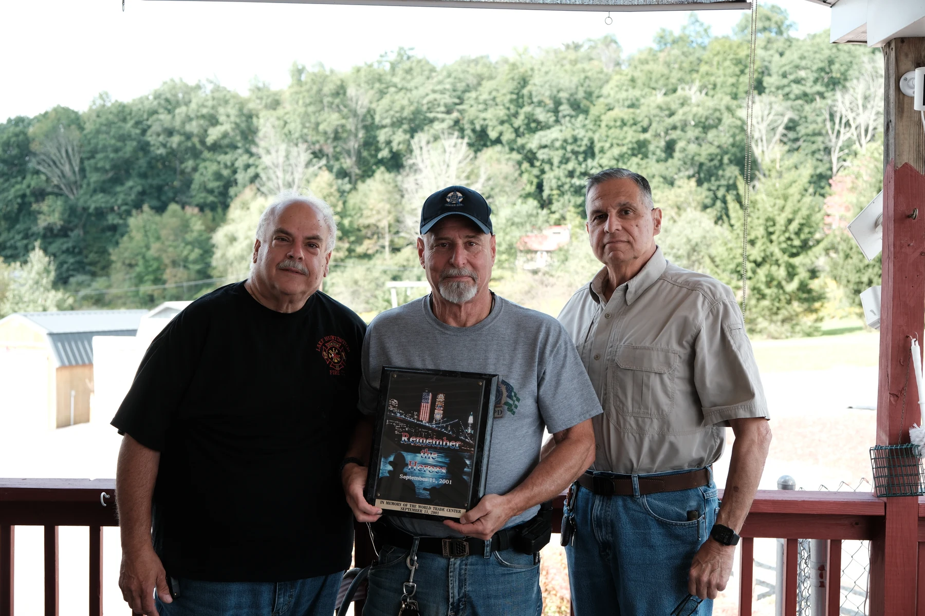 Retired NYC police detectives Joe Costa, Barry Anfang and John Tucci, from left, with a 9/11 remembrance plaque in Damascus, Pennsylvania, on September 10.