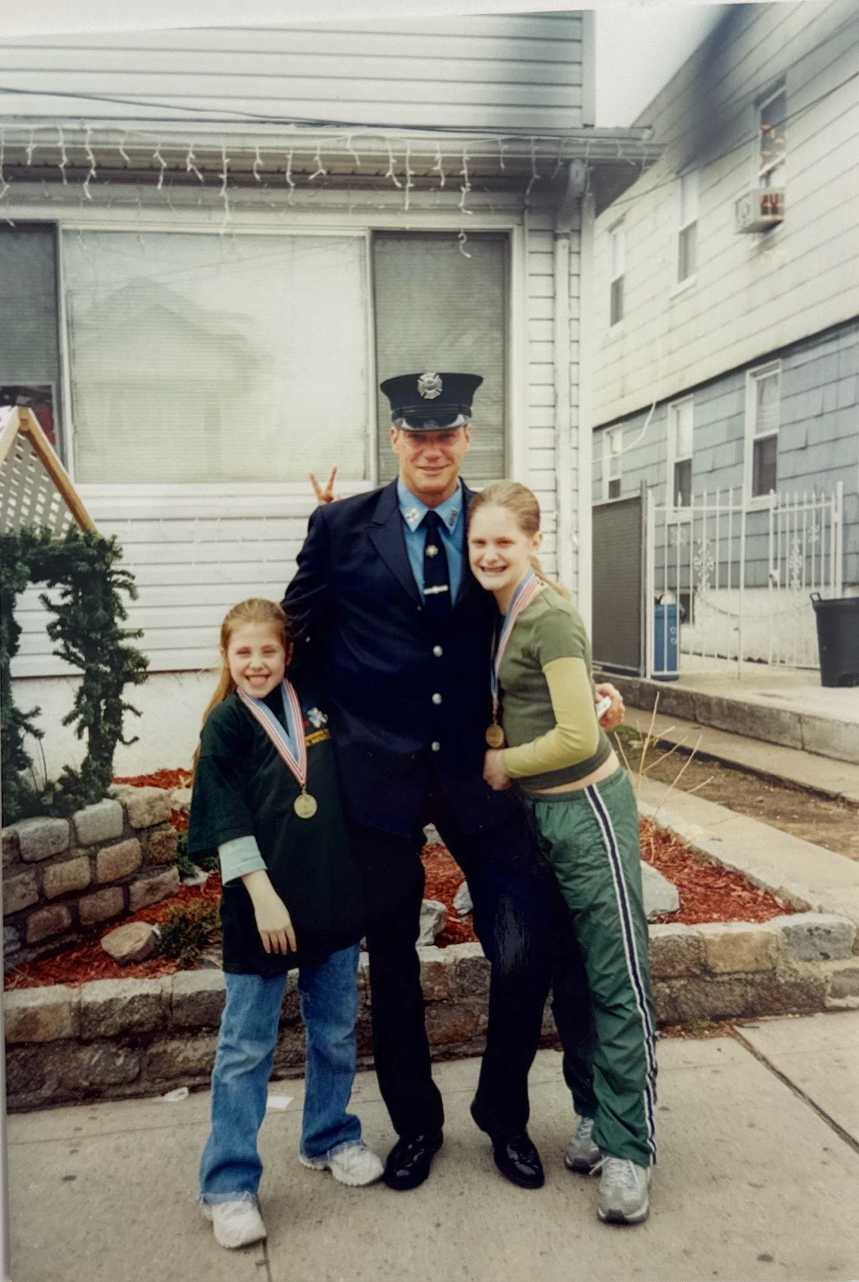 Harold “Harry” Yodice in FDNY uniform with two children. Supplied photograph from the Yodice story archive.