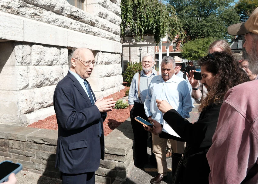 Attorney Michael Sussman, left, speaks with members of the public outside the Ulster County Courthouse following Monday’s Care Center hearing. Sullivan County Legislator Luis Alvarez, center in blue, also attended the proceeding.