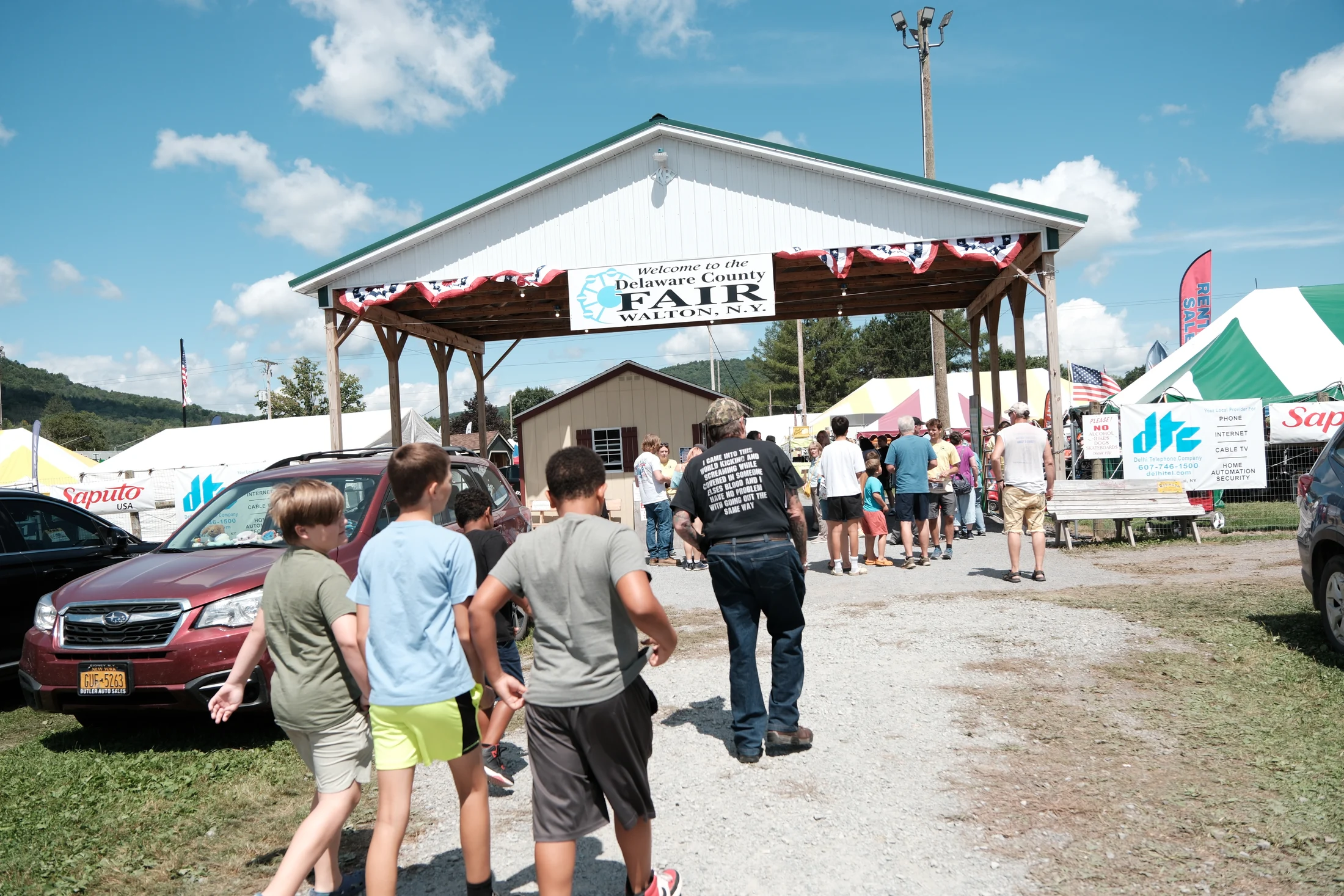 Fairgoers make their way through the entrance to the 139th Delaware County Fair in Walton.