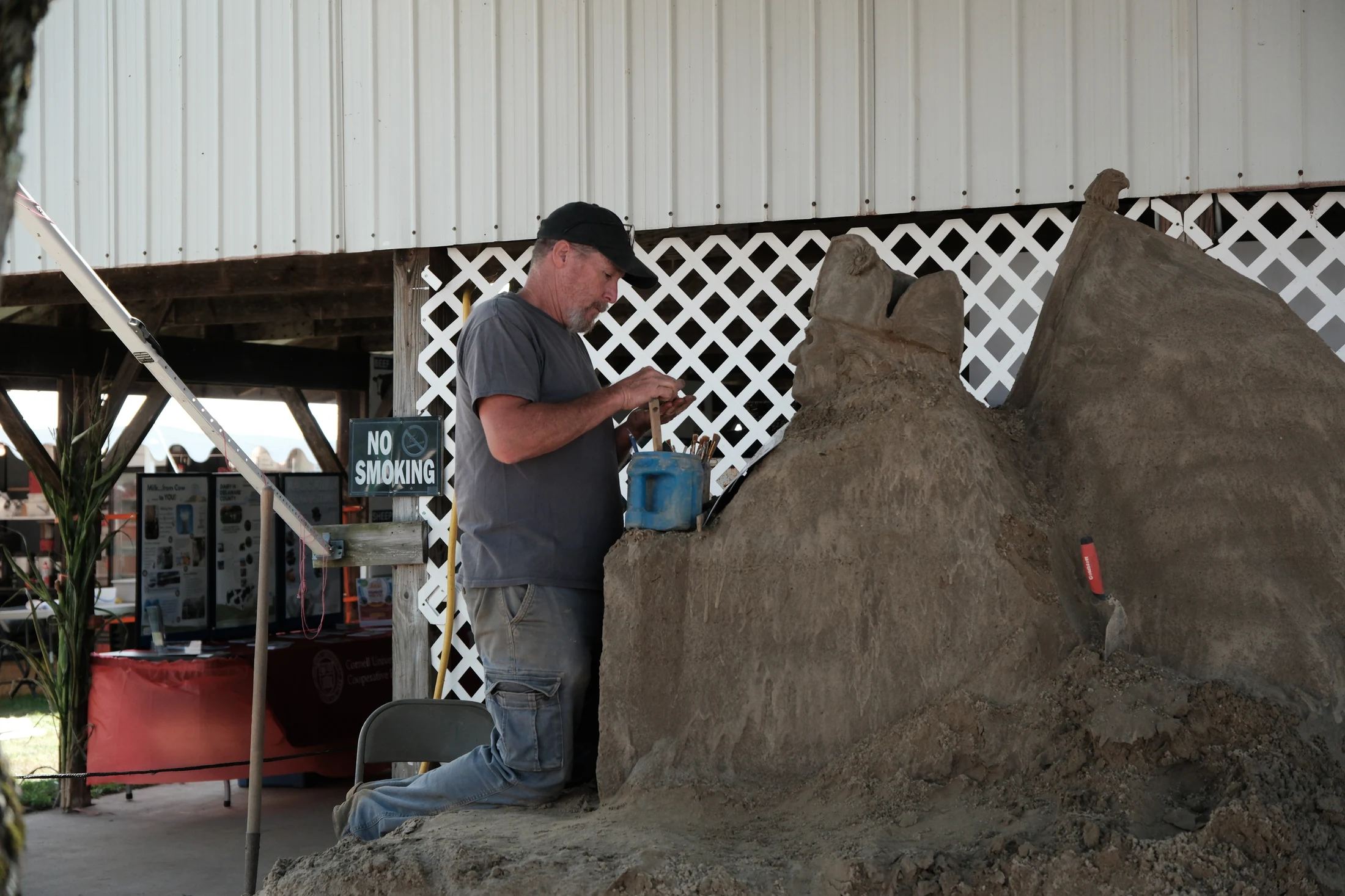 Sand sculptor Phil Singer works on a depiction of Washington Crossing the Delaware at the Delaware County Fair, one of the fair’s displays marking America’s 250th anniversary.