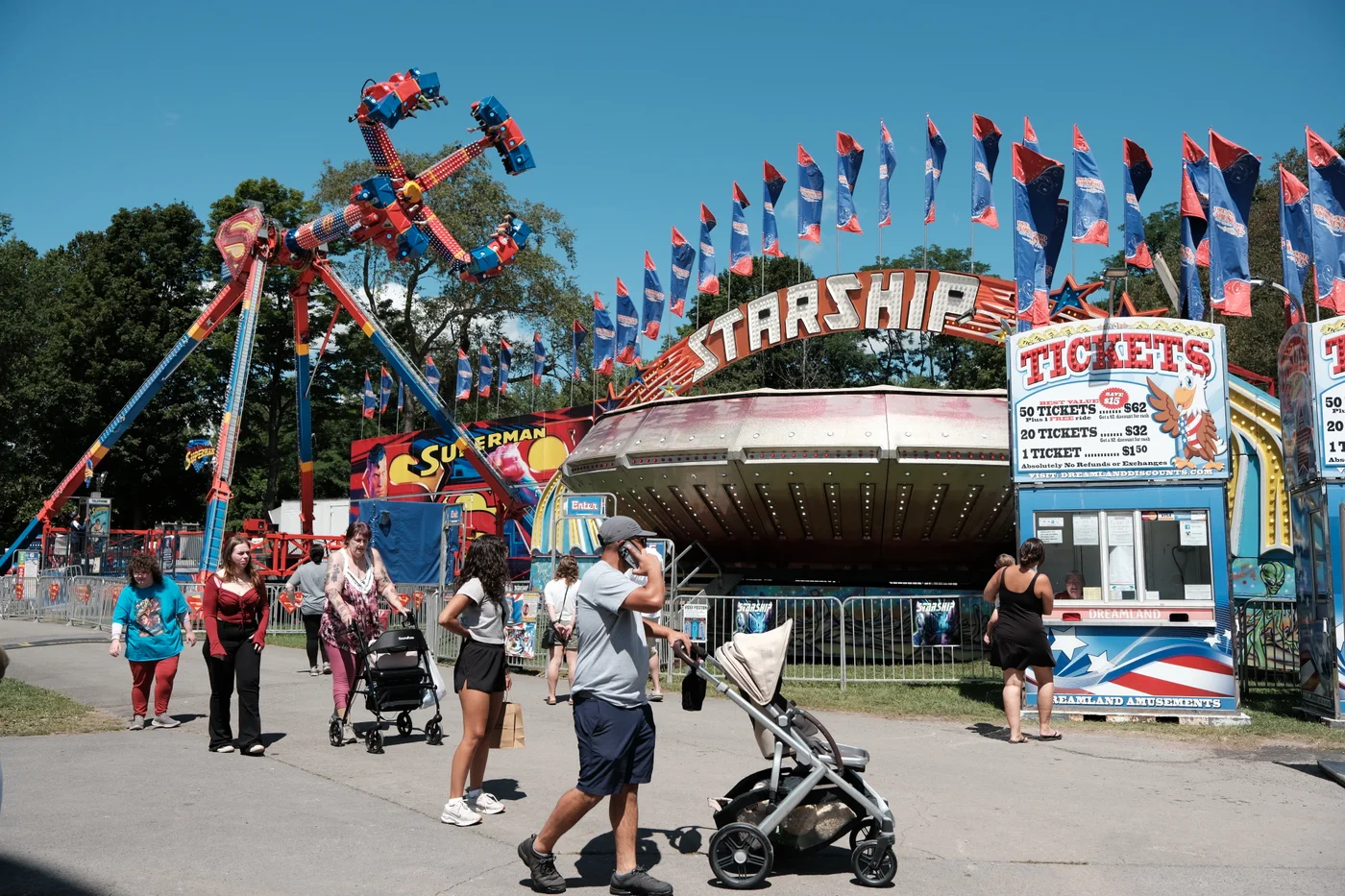 Rides, games and ticket booths fill the midway as fairgoers make their way through the Delaware County Fair.