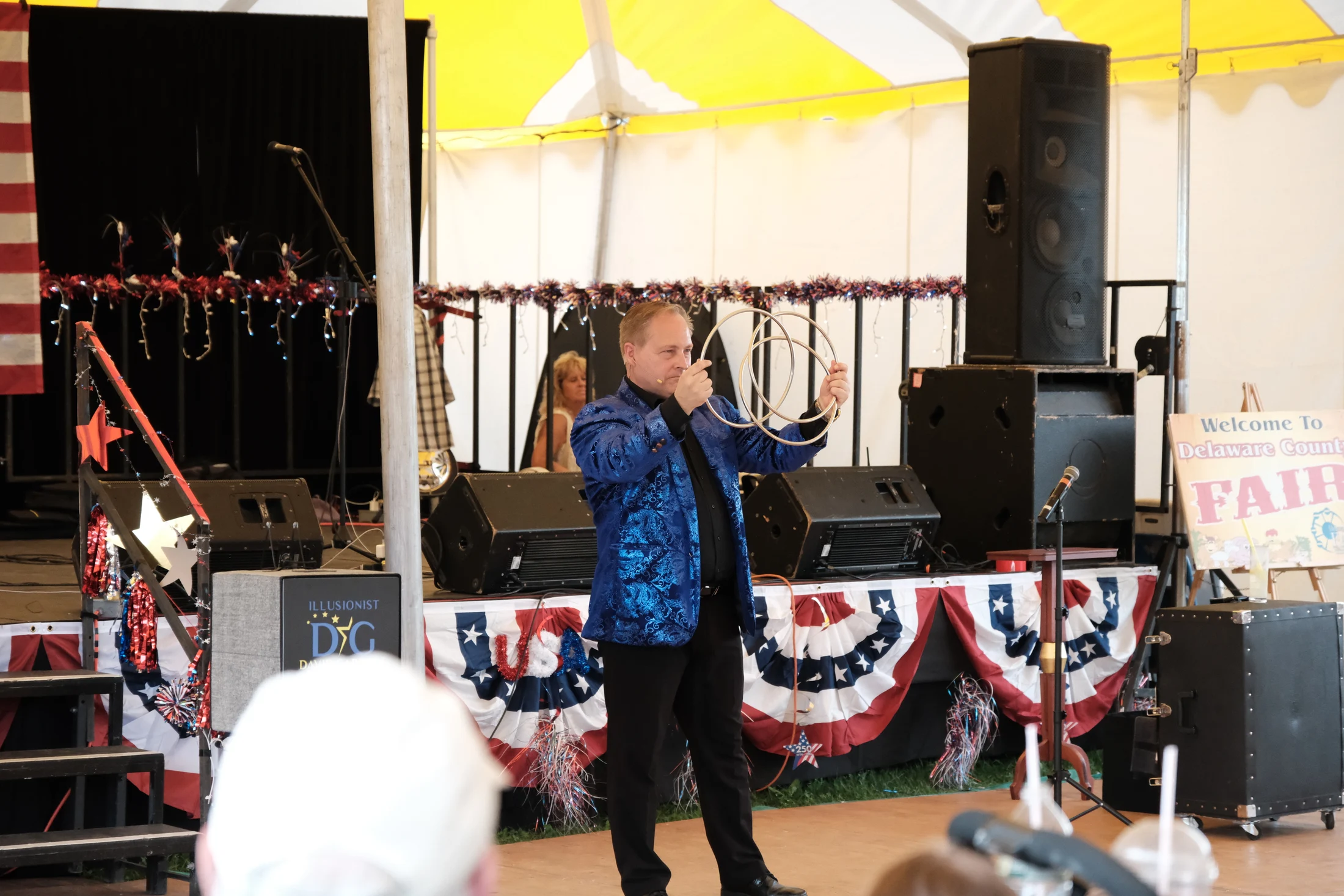 Illusionist David Garrity performs a ring illusion for an audience at the Delaware County Fair.