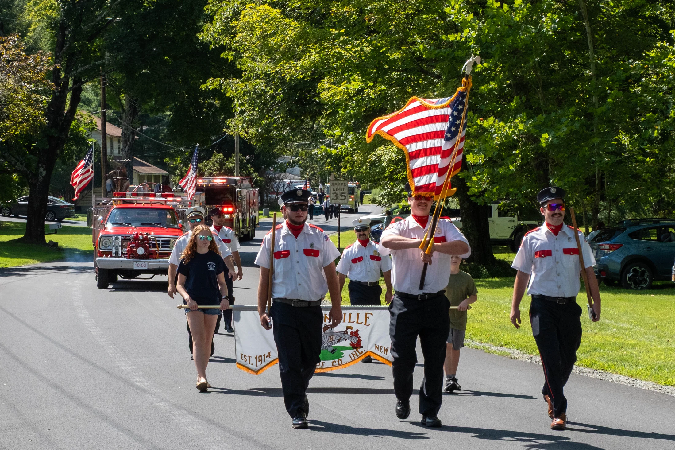 Marchers carry the colors through Hortonville during the annual firemen’s parade.