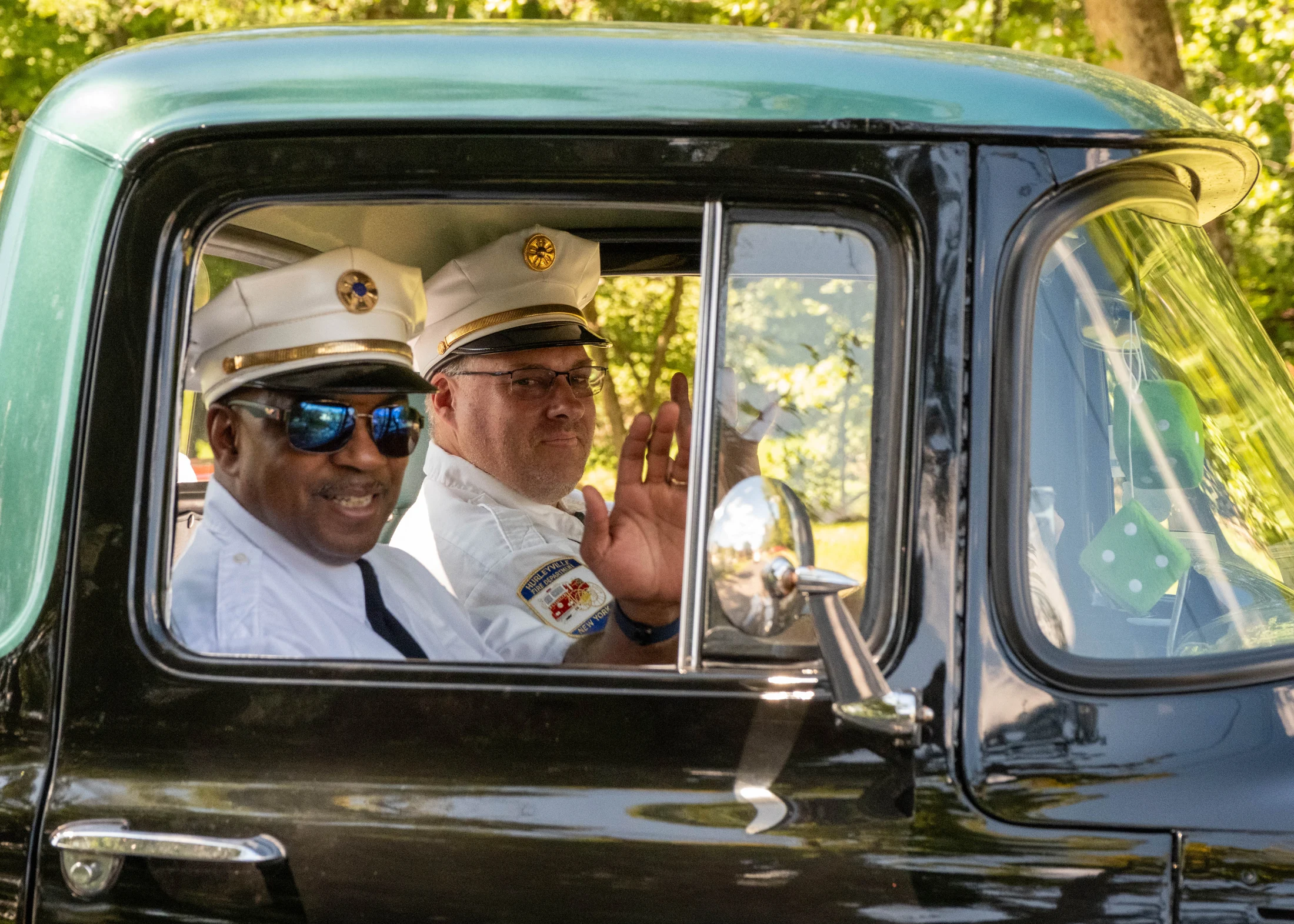 Parade participants ride in an antique fire truck in Hortonville.